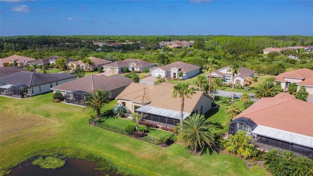 bird's eye view with a wooded view and a residential view