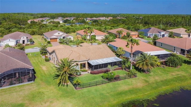 bird's eye view featuring a wooded view and a residential view
