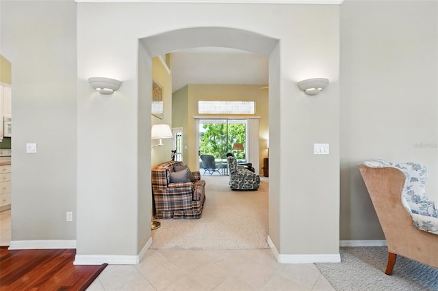 2374 Eagle Trace Dr, Kissimmee, FL 34746 - hall featuring arched walkways, light colored carpet, and baseboards