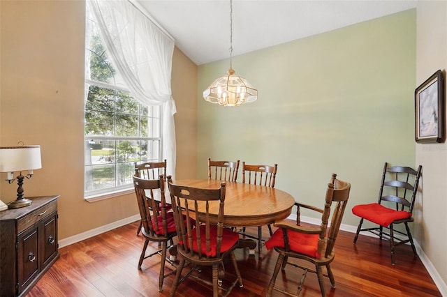 2374 Eagle Trace Dr, Kissimmee, FL 34746 - dining area featuring wood finished floors, a notable chandelier, and baseboards