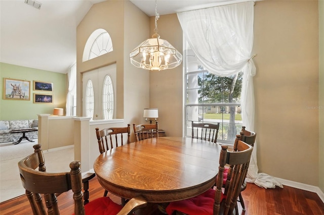 2374 Eagle Trace Dr, Kissimmee, FL 34746 - dining room featuring a notable chandelier, baseboards, wood finished floors, and a healthy amount of sunlight