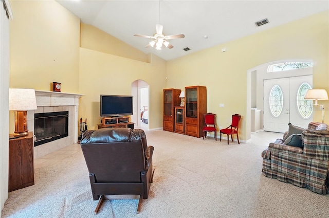2374 Eagle Trace Dr, Kissimmee, FL 34746 - living room featuring carpet flooring, visible vents, ceiling fan, arched walkways, and a fireplace
