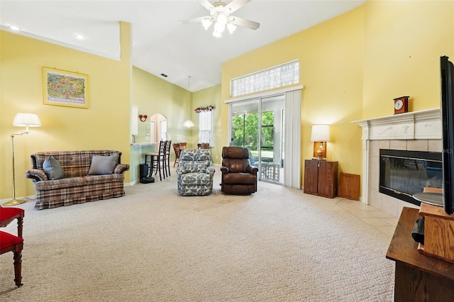 2374 Eagle Trace Dr, Kissimmee, FL 34746 - carpeted living room featuring a fireplace, a ceiling fan, high vaulted ceiling, and arched walkways