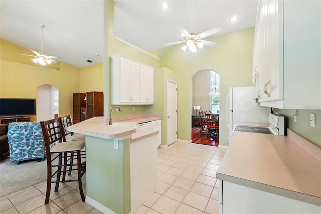 2374 Eagle Trace Dr, Kissimmee, FL 34746 - kitchen featuring high vaulted ceiling, arched walkways, and a ceiling fan
