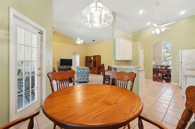2374 Eagle Trace Dr, Kissimmee, FL 34746 - dining space with light tile patterned floors, arched walkways, baseboards, and ceiling fan with notable chandelier