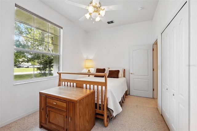 2374 Eagle Trace Dr, Kissimmee, FL 34746 - bedroom featuring a closet, ceiling fan, visible vents, baseboards, and light colored carpet
