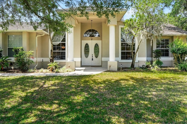 2374 Eagle Trace Dr, Kissimmee, FL 34746 - doorway to property featuring stucco siding and a yard