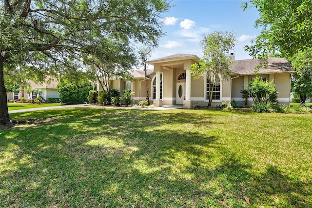 2374 Eagle Trace Dr, Kissimmee, FL 34746 - ranch-style home with a front lawn and stucco siding
