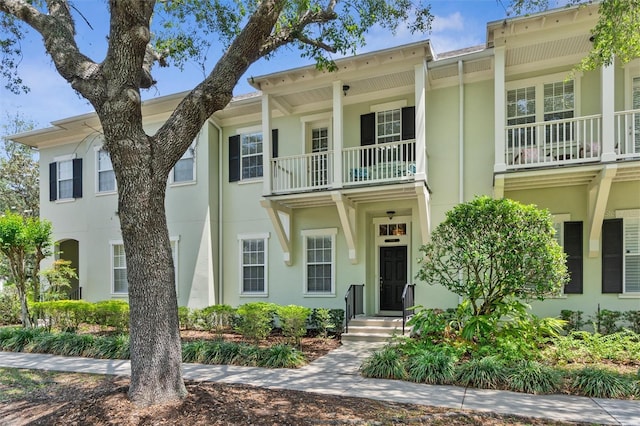 multi unit property featuring a balcony and stucco siding