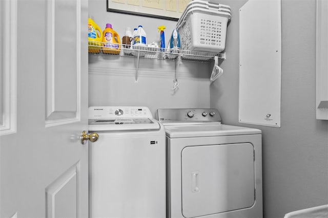 laundry room featuring separate washer and dryer and laundry area