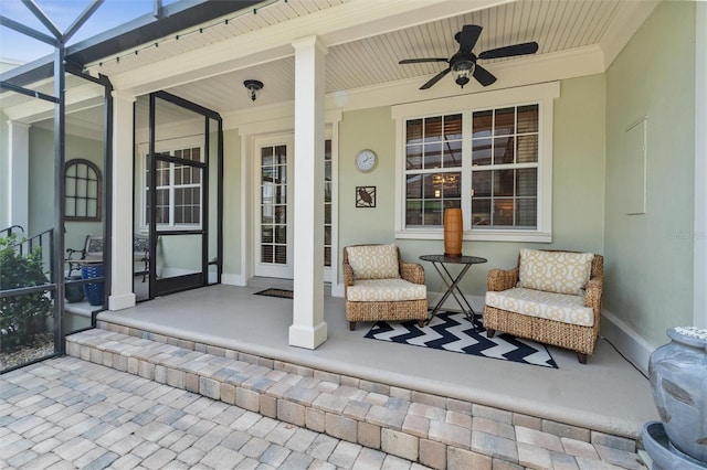view of patio / terrace with covered porch, ceiling fan, and a lanai