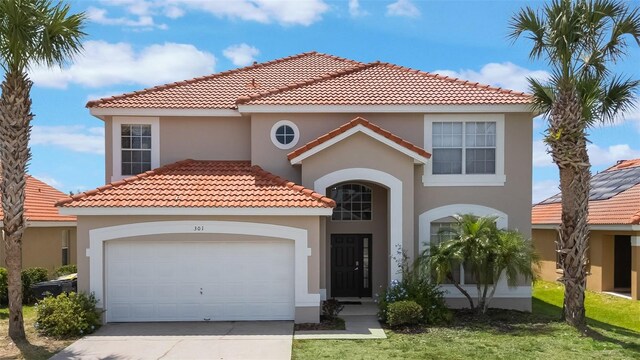 301 Rosso Dr, Davenport, FL 33837 - mediterranean / spanish-style home featuring a garage, stucco siding, driveway, and a tiled roof
