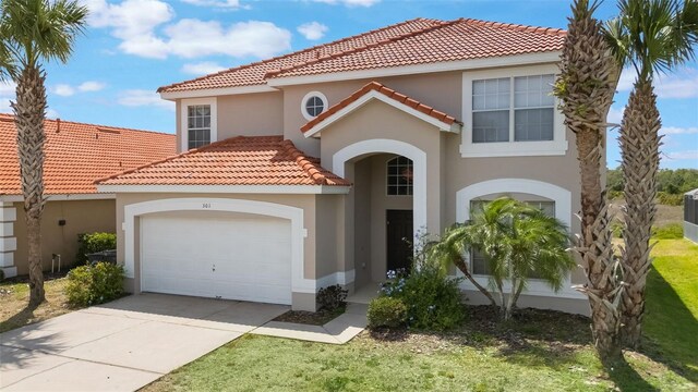 301 Rosso Dr, Davenport, FL 33837 - mediterranean / spanish home with stucco siding, a tiled roof, driveway, and a garage