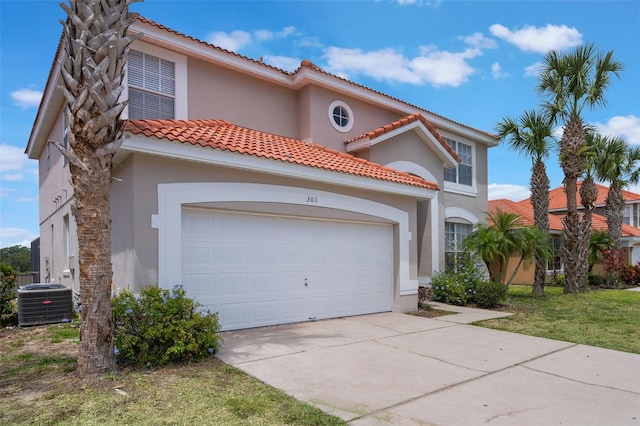 301 Rosso Dr, Davenport, FL 33837 - mediterranean / spanish home with a tile roof, driveway, stucco siding, and central AC unit