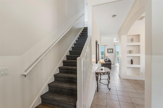 301 Rosso Dr, Davenport, FL 33837 - stairs with tile patterned flooring, visible vents, and built in features