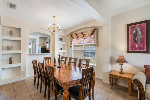 301 Rosso Dr, Davenport, FL 33837 - dining area with a wealth of natural light, visible vents, arched walkways, and built in shelves