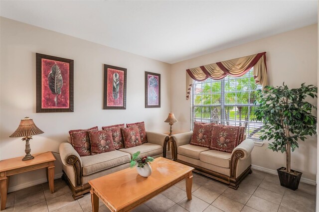 301 Rosso Dr, Davenport, FL 33837 - living room featuring baseboards and light tile patterned floors