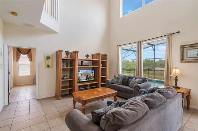 301 Rosso Dr, Davenport, FL 33837 - living area featuring visible vents, a wealth of natural light, a high ceiling, and light tile patterned flooring