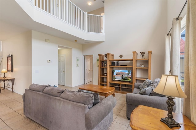 301 Rosso Dr, Davenport, FL 33837 - living room featuring a towering ceiling, light tile patterned flooring, and baseboards