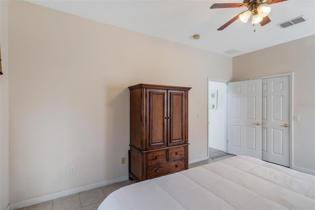 301 Rosso Dr, Davenport, FL 33837 - bedroom featuring light tile patterned floors, visible vents, a ceiling fan, and baseboards