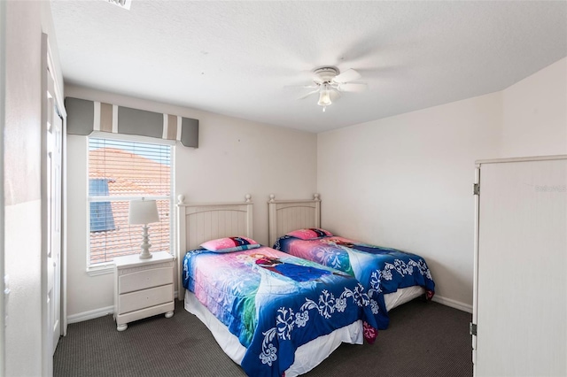 301 Rosso Dr, Davenport, FL 33837 - bedroom featuring a ceiling fan, dark carpet, and baseboards