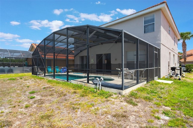 301 Rosso Dr, Davenport, FL 33837 - back of property with stucco siding, a hot tub, a patio, a tile roof, and an outdoor pool