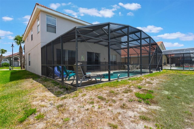 301 Rosso Dr, Davenport, FL 33837 - back of house featuring a lanai, stucco siding, a yard, and an outdoor pool