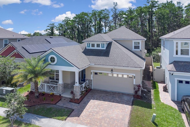 2487 Empress Dr, Kissimmee, FL 34741 - craftsman inspired home featuring covered porch, a front yard, decorative driveway, roof with shingles, and stucco siding