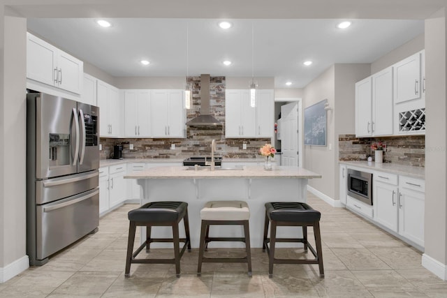 2487 Empress Dr, Kissimmee, FL 34741 - kitchen with decorative backsplash, a breakfast bar, wall chimney range hood, white cabinets, and stainless steel appliances