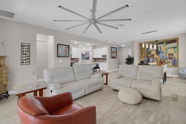 2487 Empress Dr, Kissimmee, FL 34741 - living area with ceiling fan, visible vents, and baseboards