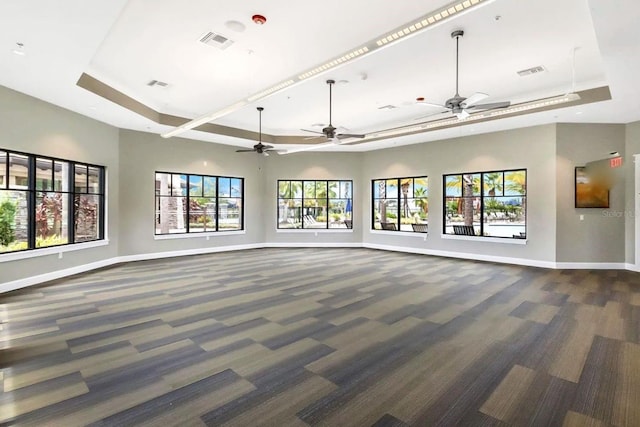 2487 Empress Dr, Kissimmee, FL 34741 - unfurnished living room with a ceiling fan, a tray ceiling, and visible vents