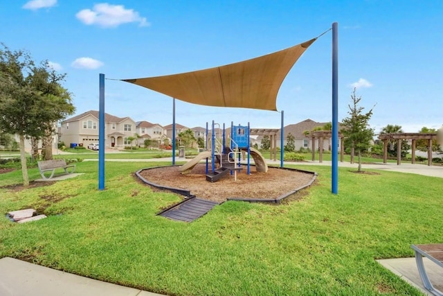 2487 Empress Dr, Kissimmee, FL 34741 - community play area with a lawn, a pergola, and a residential view