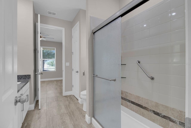 2487 Empress Dr, Kissimmee, FL 34741 - bathroom featuring ceiling fan, visible vents, a stall shower, vanity, and toilet