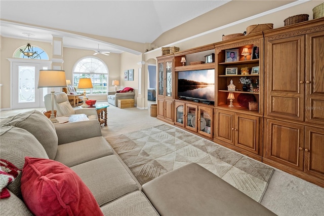 living area featuring a ceiling fan, lofted ceiling, and light colored carpet