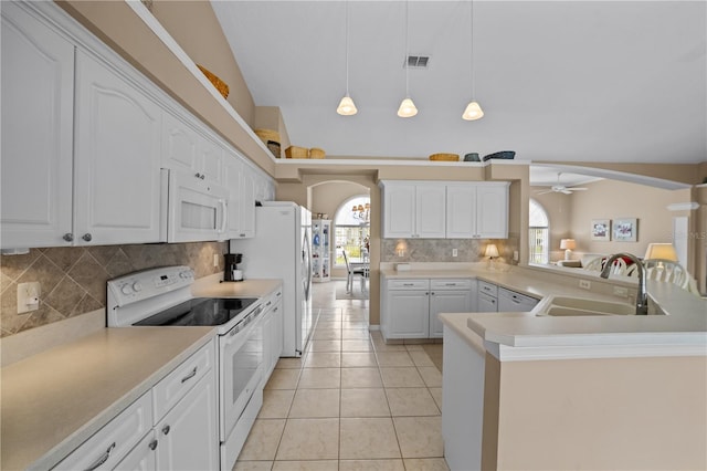 kitchen featuring plenty of natural light, a ceiling fan, a sink, and white appliances