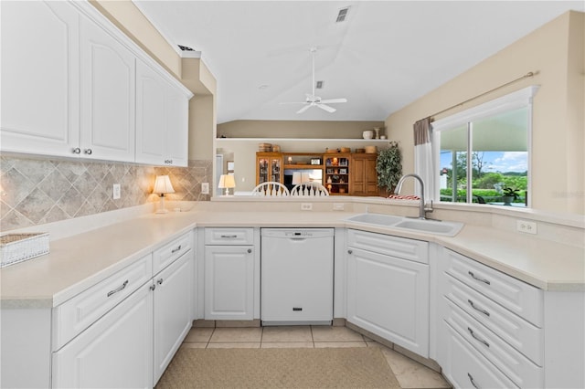 kitchen with a sink, ceiling fan, visible vents, vaulted ceiling, and dishwasher