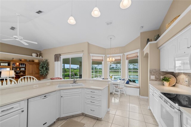 kitchen featuring ceiling fan with notable chandelier, visible vents, white appliances, and a sink