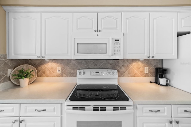 kitchen with light countertops, tasteful backsplash, white cabinetry, and white appliances