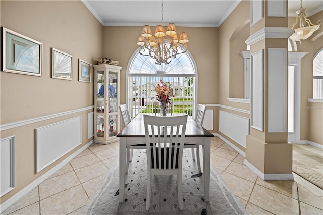 dining room featuring ornamental molding, light tile patterned flooring, arched walkways, and a chandelier