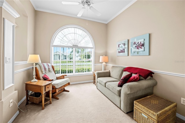 carpeted living room featuring ornamental molding, ceiling fan, and baseboards