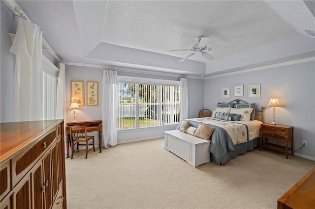 bedroom featuring light colored carpet, baseboards, a tray ceiling, and a textured ceiling