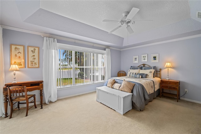 bedroom with baseboards, carpet, and a tray ceiling