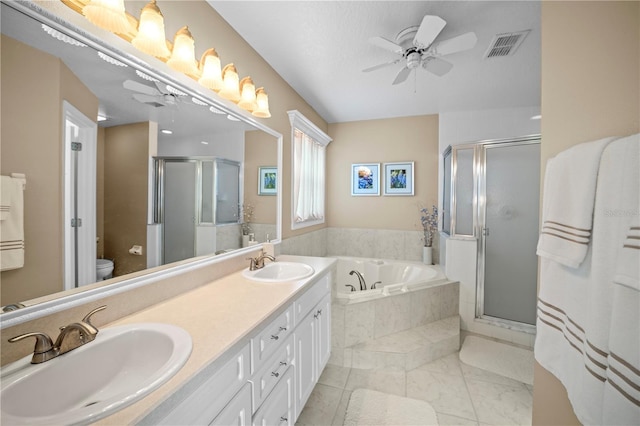 bathroom featuring a shower stall, ceiling fan, and a sink