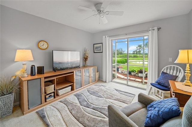 living room featuring a ceiling fan and carpet flooring