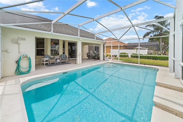 view of swimming pool with a patio area, glass enclosure, and a fenced in pool