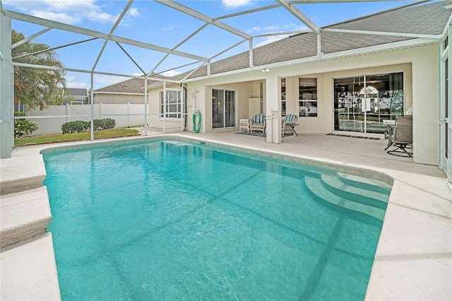 view of swimming pool featuring fence, a lanai, a fenced in pool, and a patio area