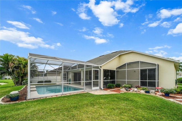 rear view of house with a patio area, stucco siding, a fenced in pool, and a lawn