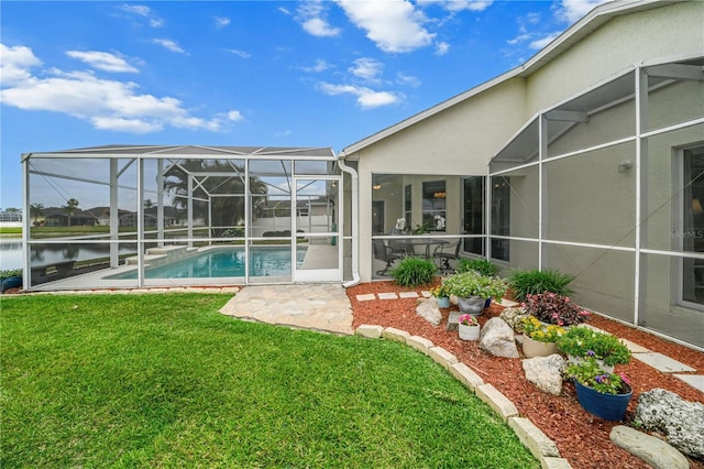 outdoor pool with a patio, a yard, and a lanai