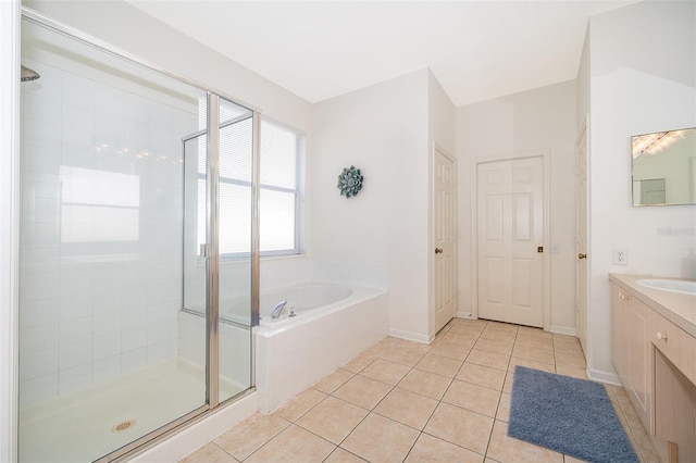 bathroom with tile patterned flooring, a bath, a stall shower, and vanity