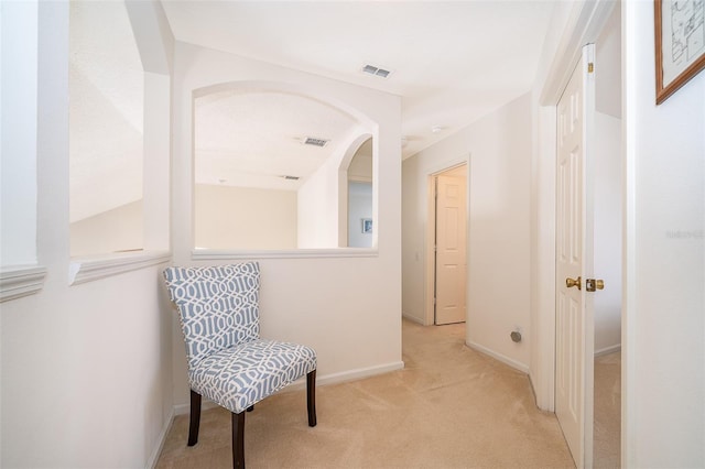 sitting room with visible vents, baseboards, and carpet floors